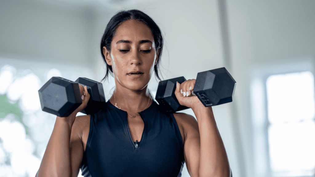 woman weight lifting with two dumbbells