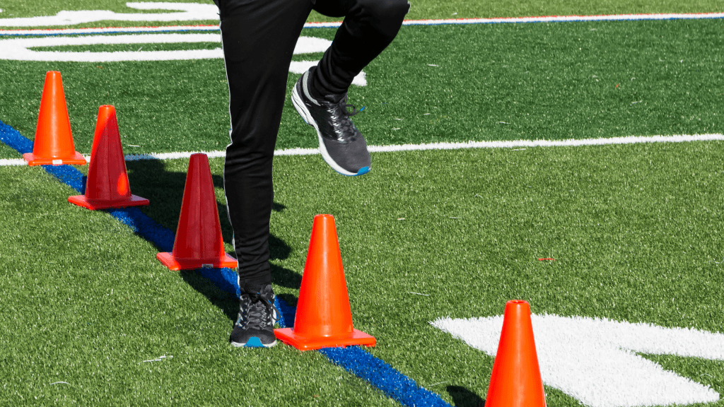 man doing plyometrics with cones
